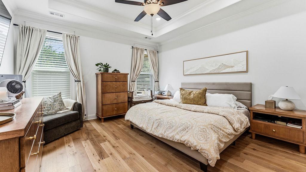 Image 4: Spacious room featuring wood-finish flooring, a tr