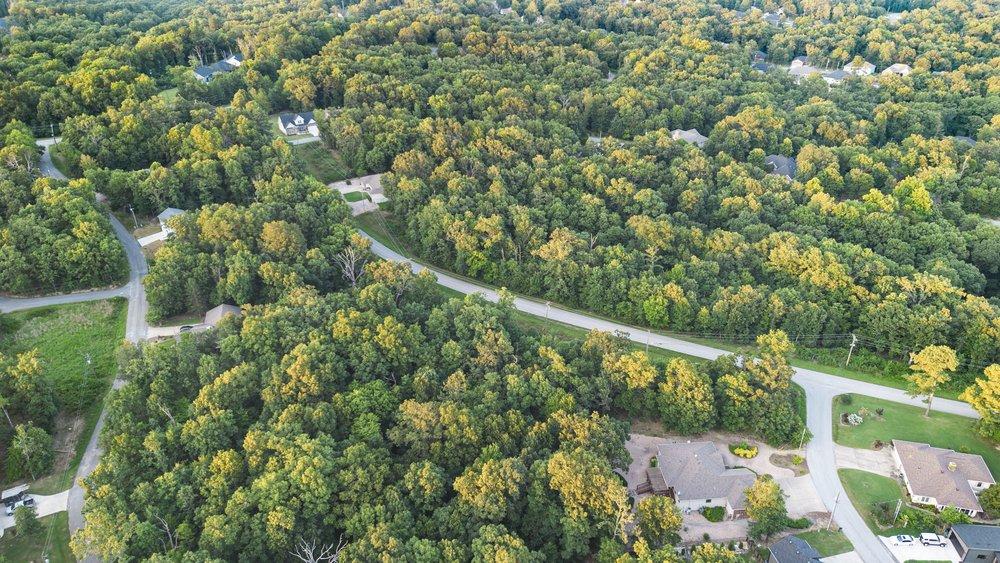 Image 4: Expansive wooded setting featuring mature trees an