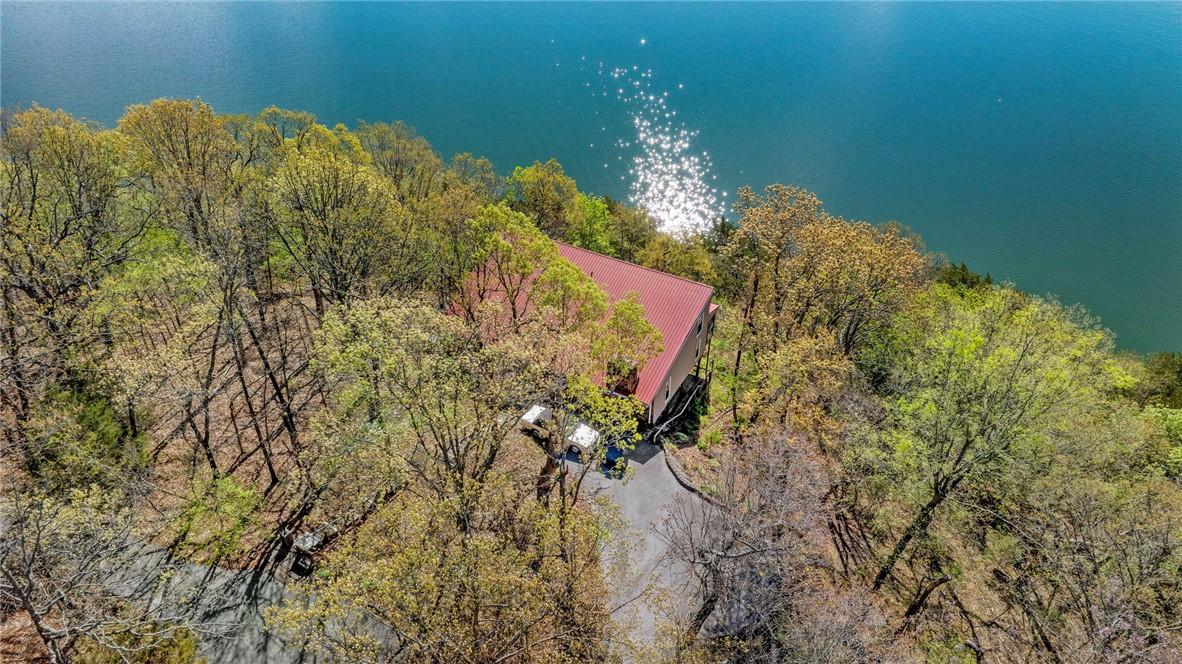 Image 2: Home is nestled among mature trees, with a complet