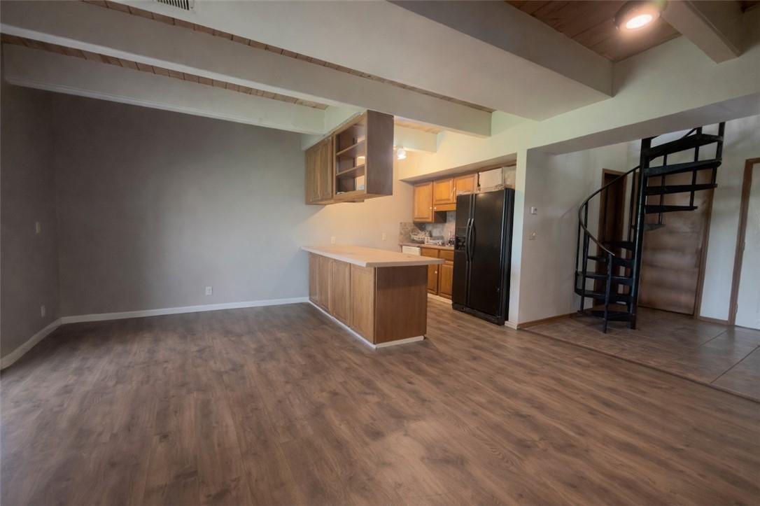 Image 2: Kitchen featuring beam ceiling, a peninsula, black
