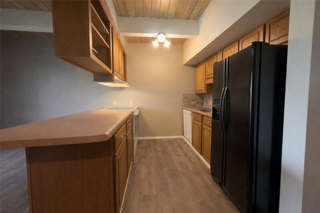 Image 4: Kitchen with a wooden ceiling with exposed beams,
