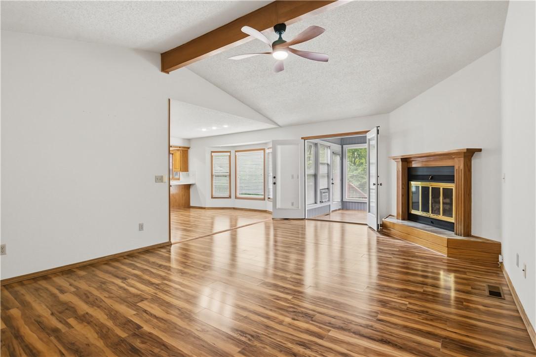 Image 4: Vaulted ceiling living space featuring wood-finish