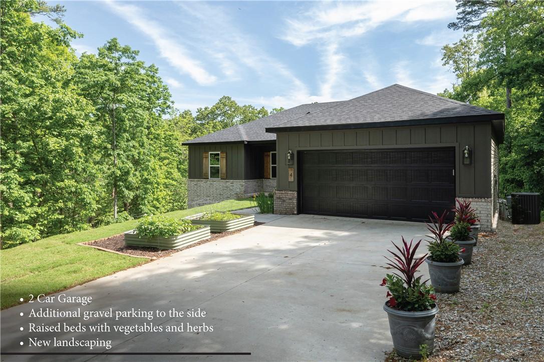 Image 4: Modern dwelling featuring a dark gray garage door,