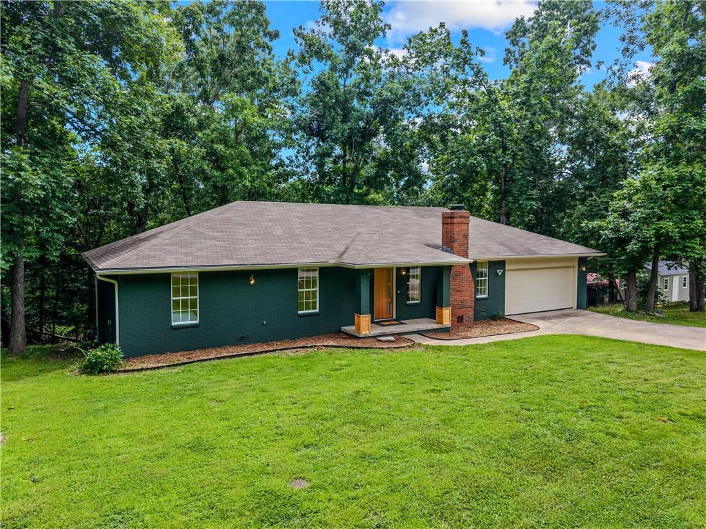 Image 4: Ranch-style residence featuring a dark green exter