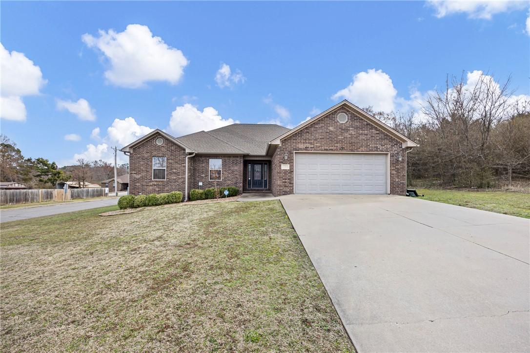 Image 1: Single story home featuring brick siding, driveway
