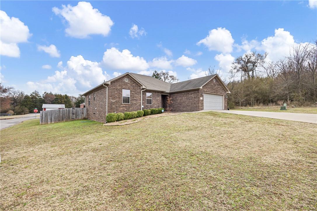 Image 2: Ranch-style house with brick siding, concrete driv