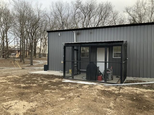 Image 3: Rear view of house featuring an outdoor structure,