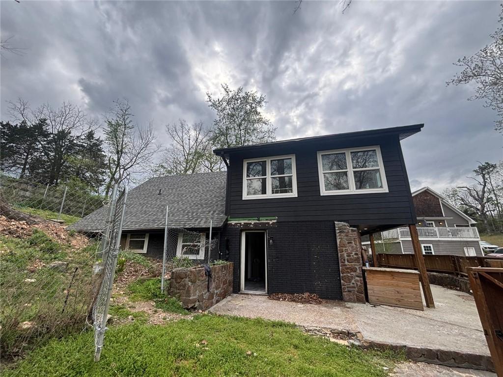 Image 4: The property features a dark exterior with white-f