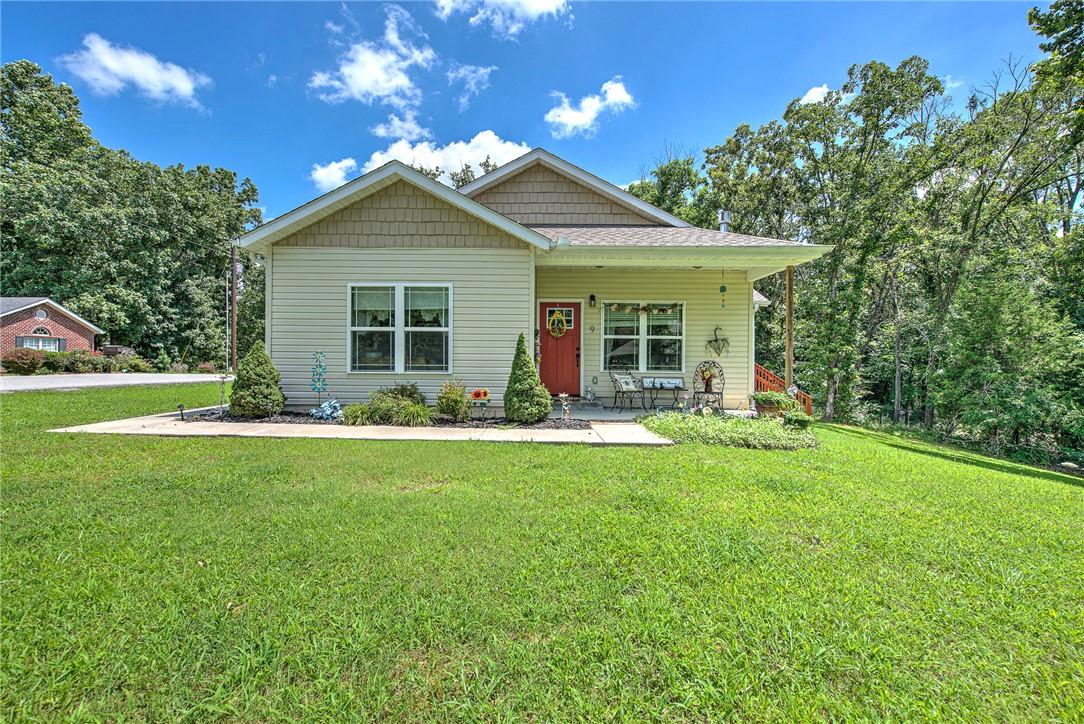 Image 1: Single-story home featuring light-colored siding,
