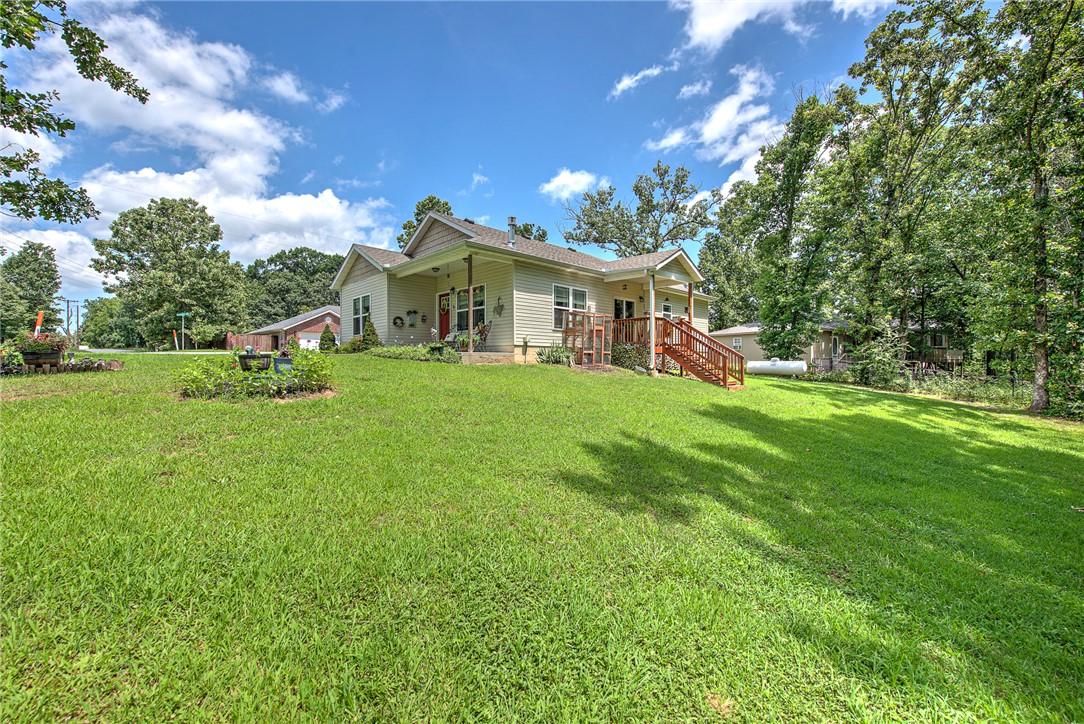 Image 3: Spacious lawn with a single-story residence featur