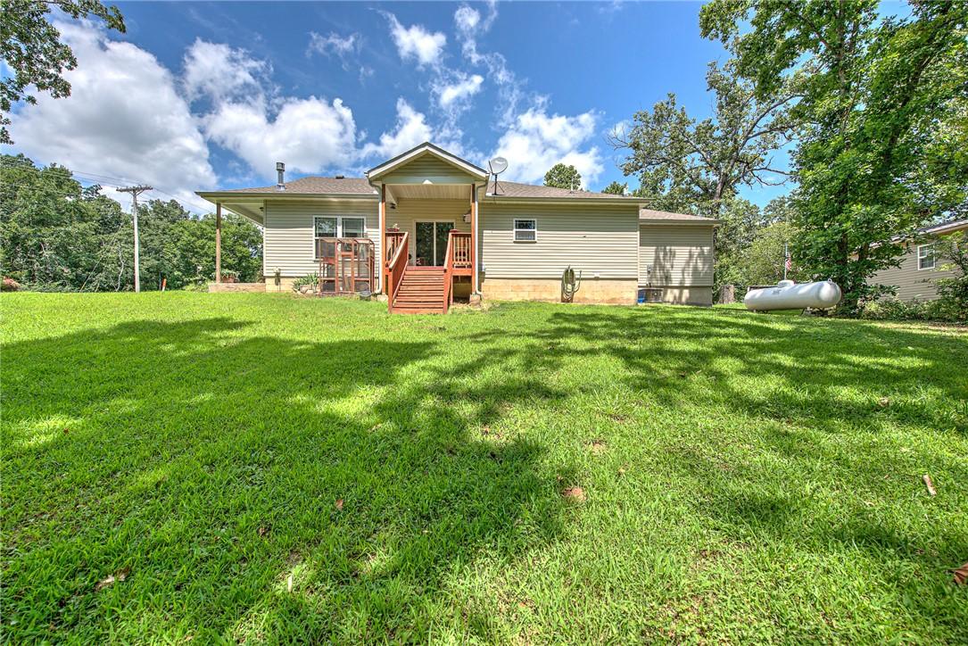 Image 4: Expansive green lawn bordering a single-story resi