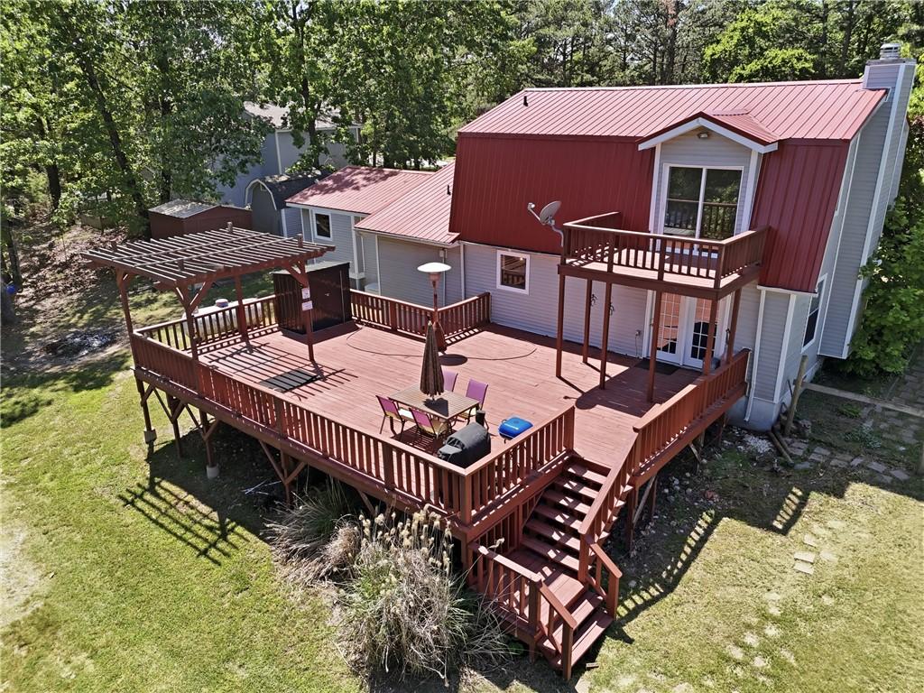 Image 1: Expansive multi-level wood deck featuring a pergol