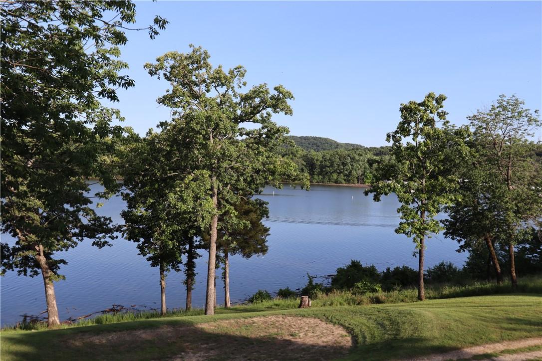 Image 3: Lakefront property featuring mature trees and a ma