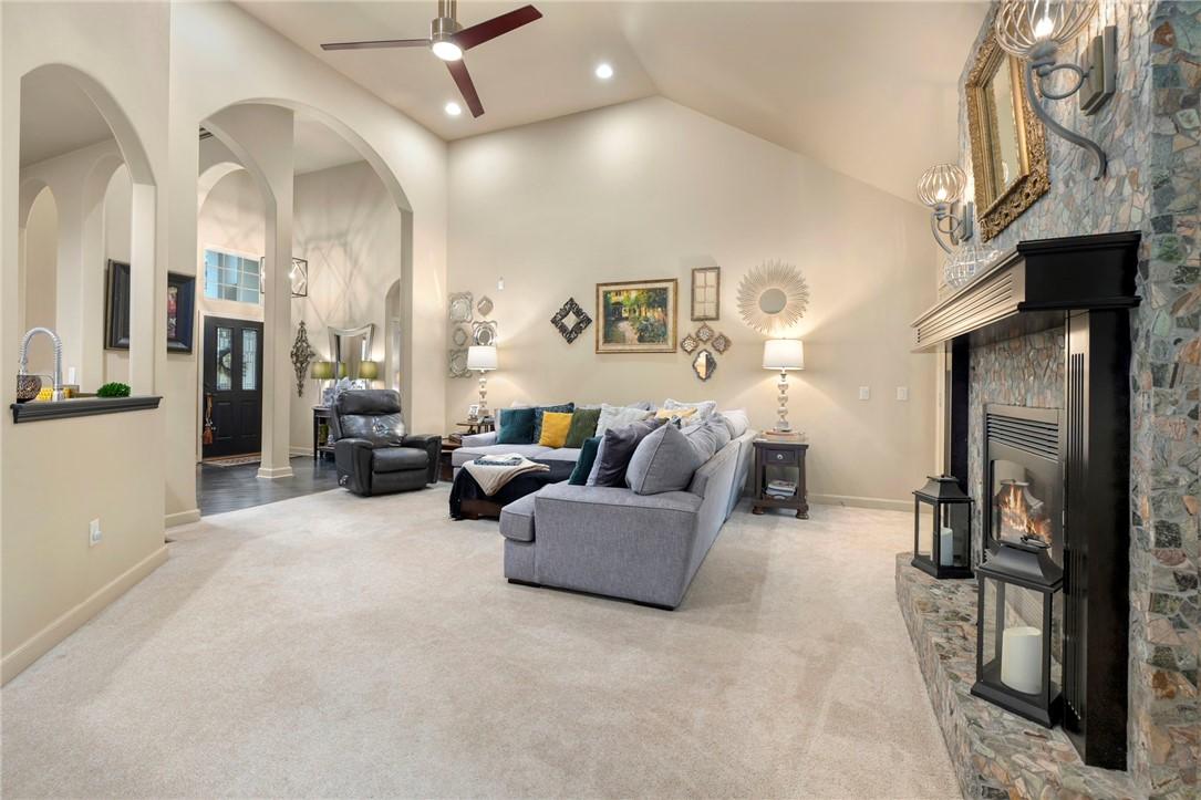 Image 3: The living room features ample lighting and cathed