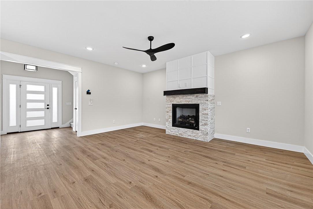 Image 2: Unfurnished living room featuring ceiling fan, a f