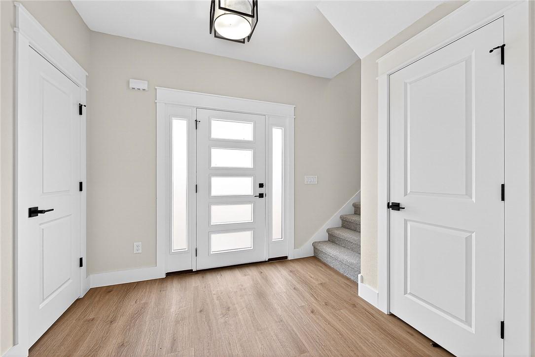 Image 3: Entrance foyer with light wood-type flooring and s
