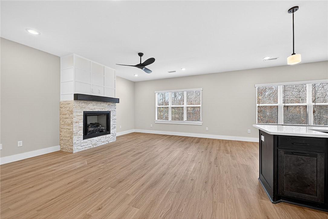 Image 4: Unfurnished living room with light wood-style floo