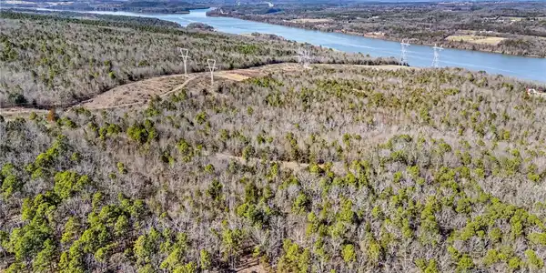 Image 4: Bird's eye view of a heavily wooded area and a lar