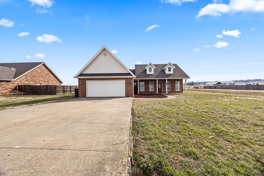 Image 2: View of front of house featuring concrete driveway