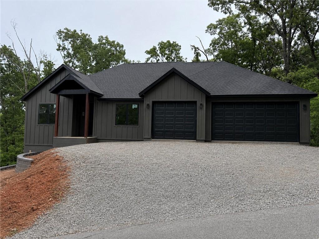 Image 1: Contemporary residence featuring dark vertical sid