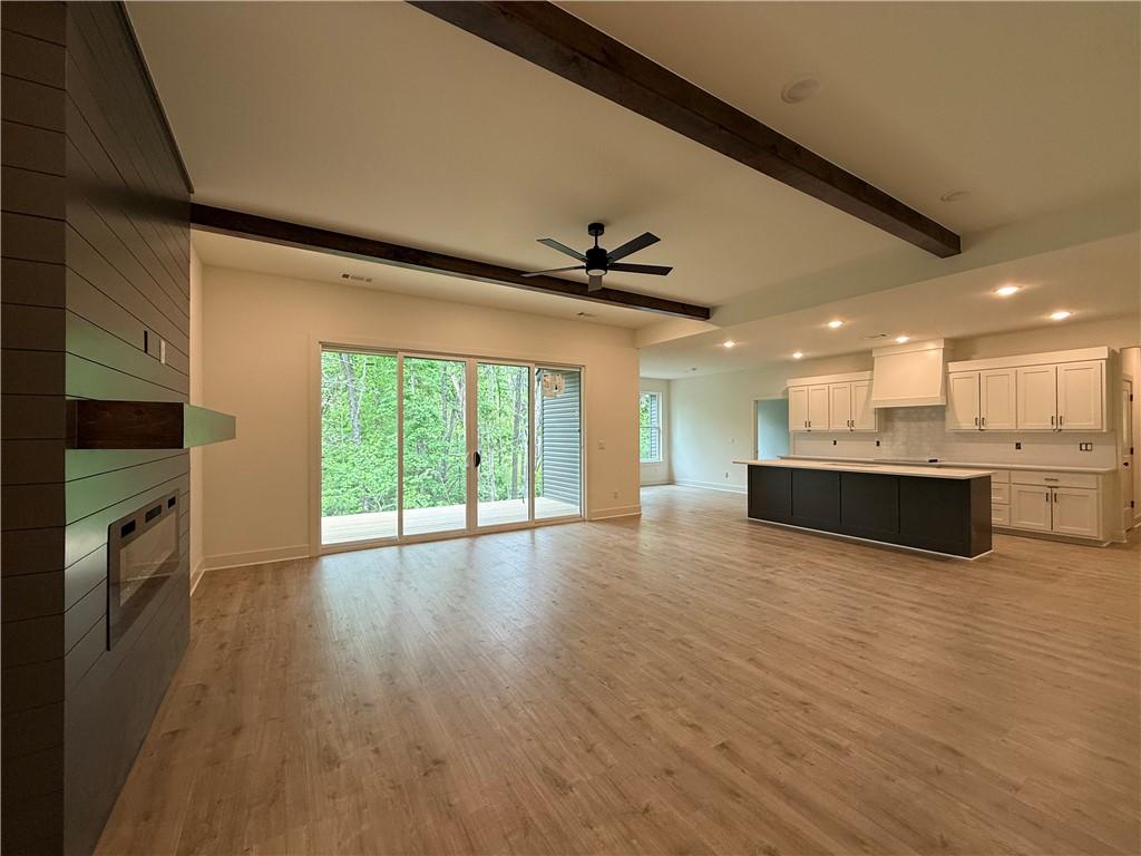 Image 3: Spacious open-concept interior featuring light woo