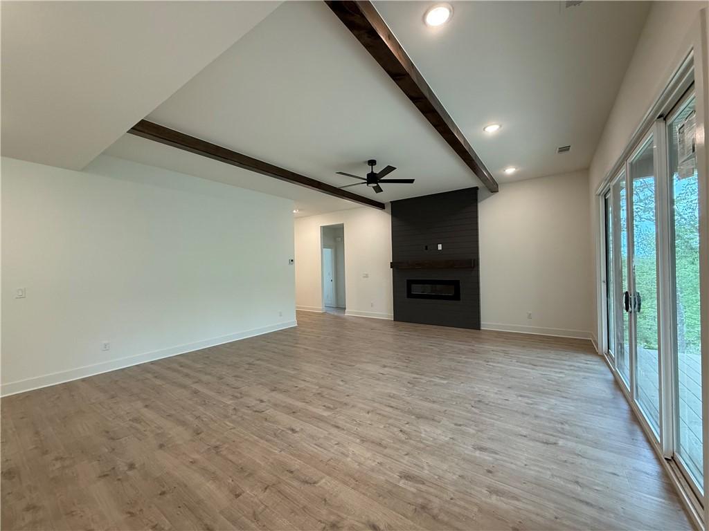 Image 4: Spacious interior featuring wood-finish flooring,