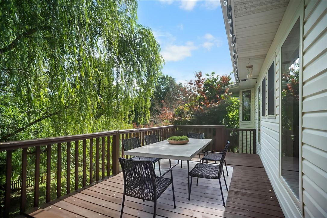 Image 4: Spacious wooden deck featuring a full railing, mul