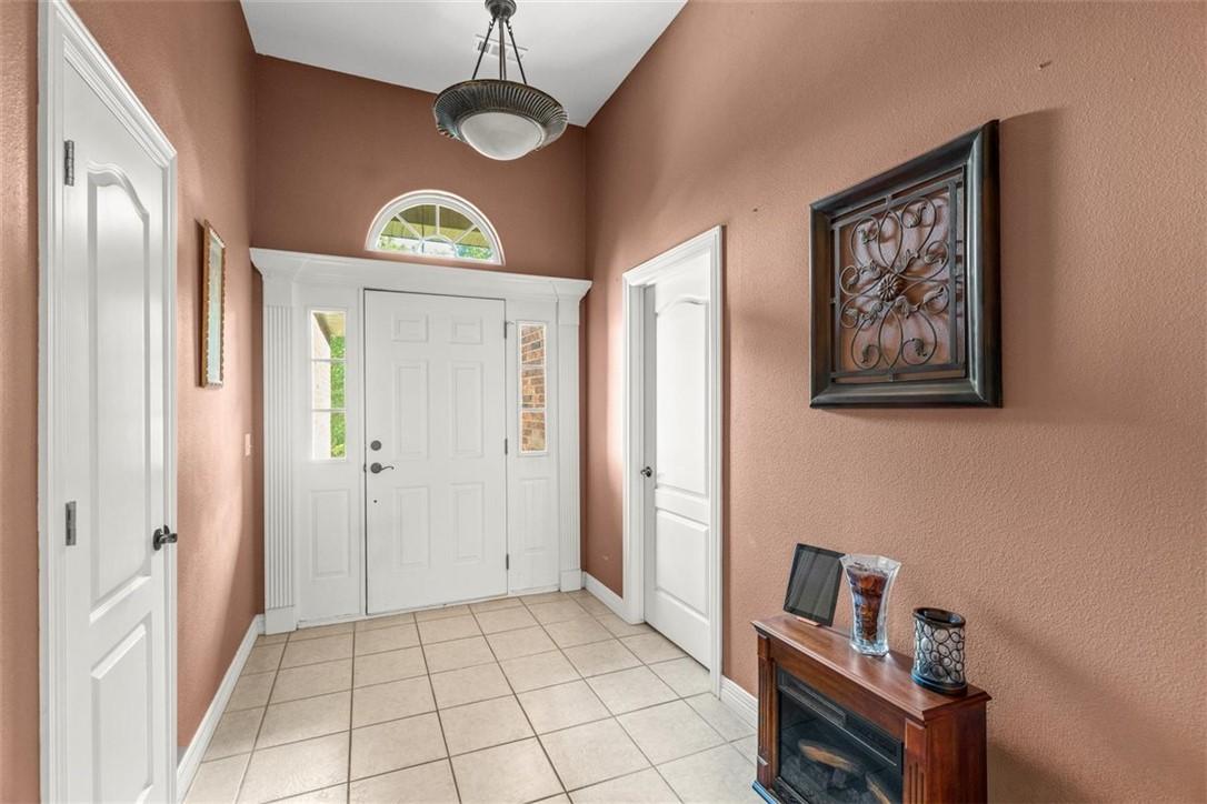 Image 2: Entryway featuring a paneled front door with sidel