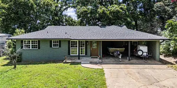 Image 2: Single-story residence featuring a dark gray shing