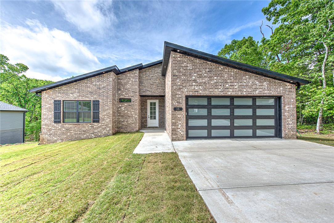 Image 1: Contemporary brick exterior with a sloped roofline