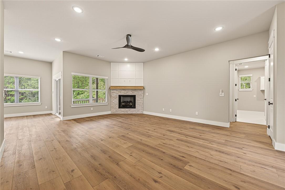 Image 2: Spacious living area featuring wood-finish floorin