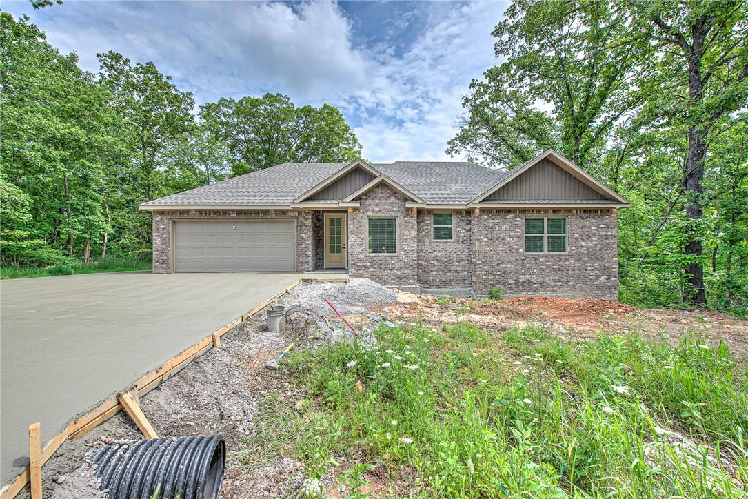 Image 1: Ranch-style residence featuring a brick facade, ne