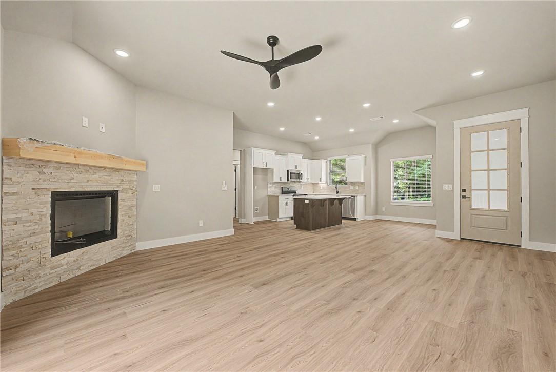 Image 4: Spacious living area featuring light wood-finish f