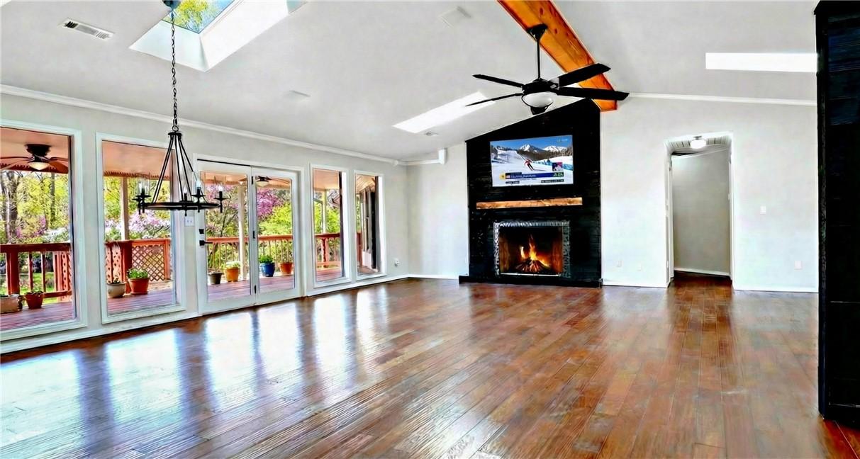 Image 3: Spacious interior featuring wood-finish flooring,