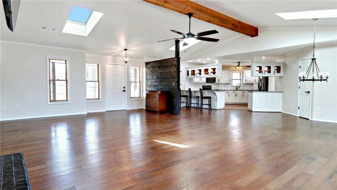 Image 4: Open-concept living space featuring wood-finish fl