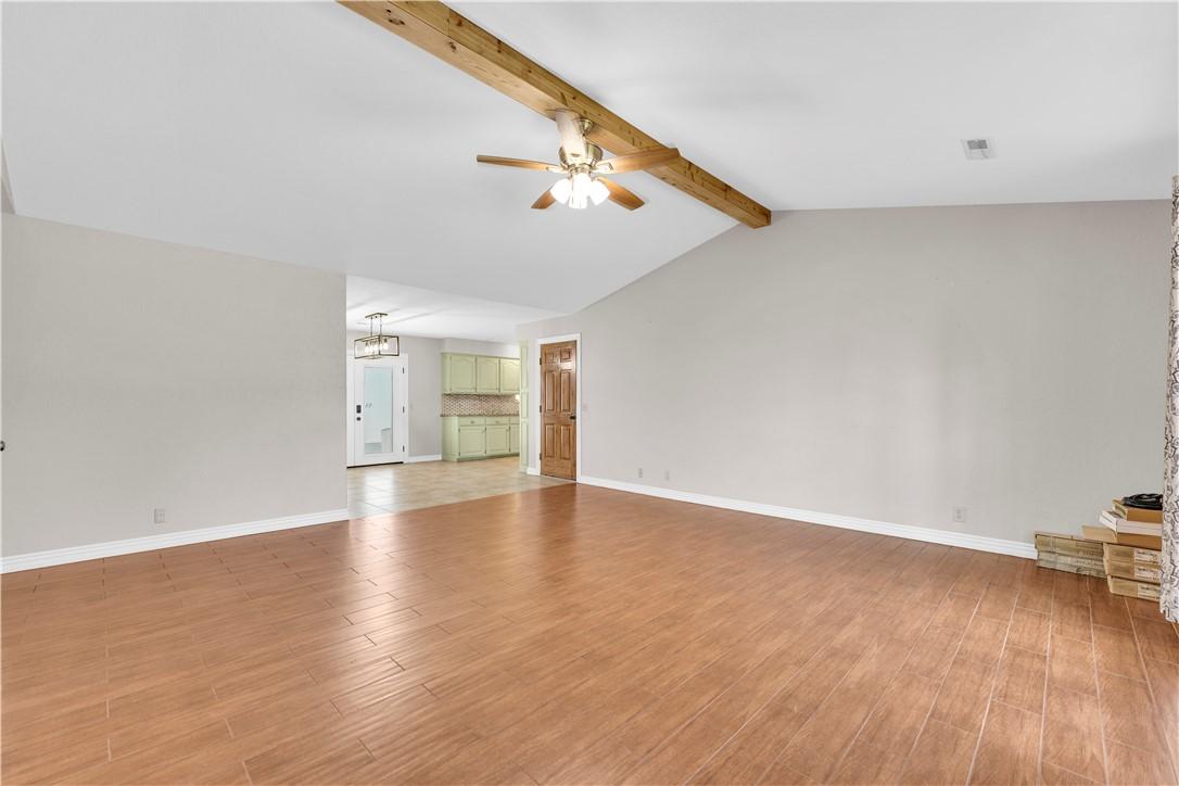 Image 3: Spacious room featuring wood-finish flooring, a va
