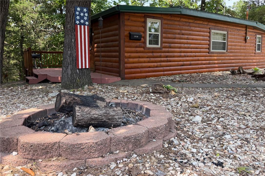 Image 3: Front exterior featuring wood-log siding and multi