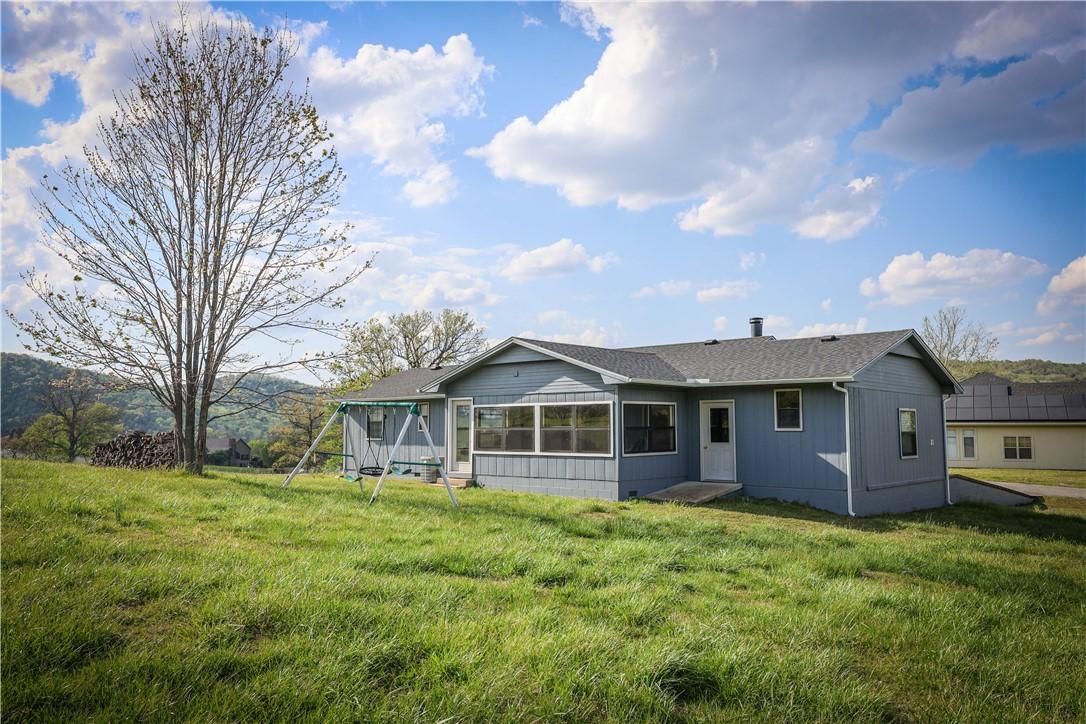 Image 4: The home  features freshly painted blue exterior,