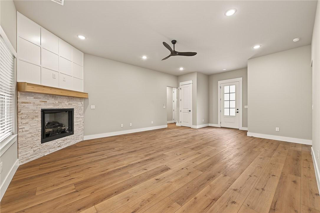 Image 4: Spacious room featuring wood-finish flooring, a co