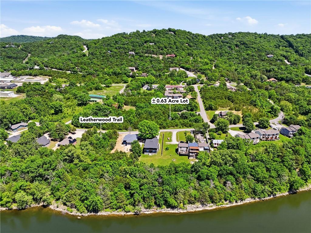 Image 2: Aerial perspective showcasing a 0.63 acre lot surr