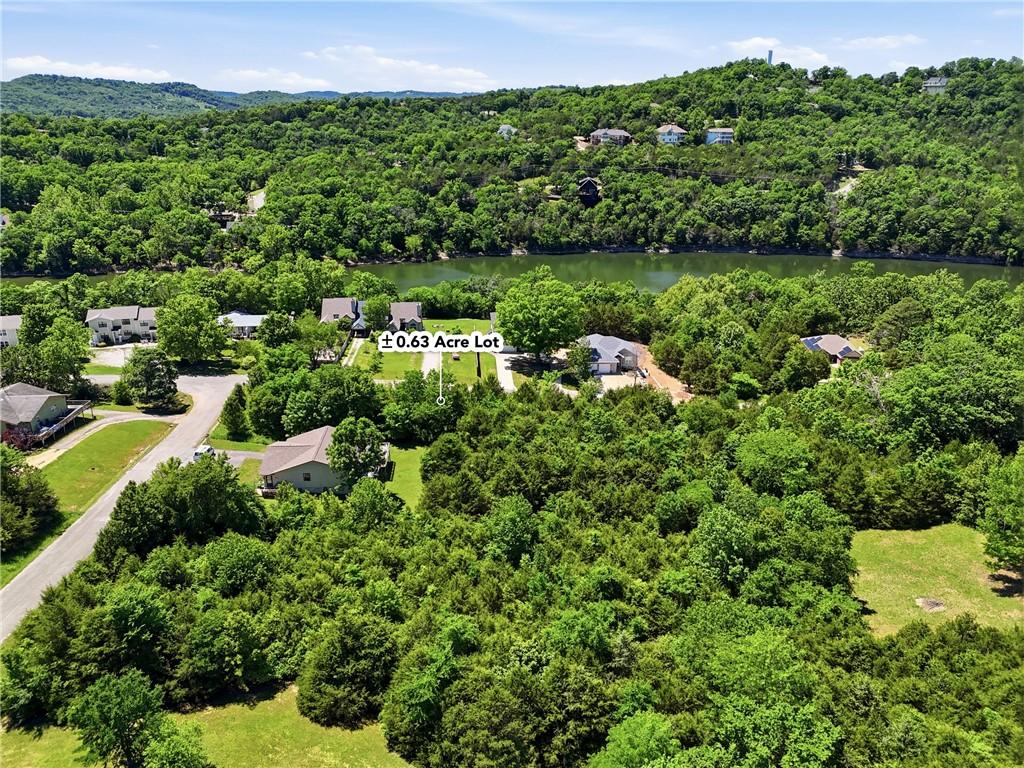 Image 3: Expansive &plusmn;0.63 acre lot featuring mature trees an