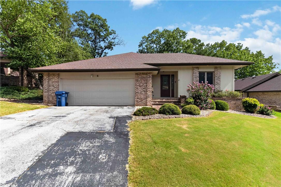 Image 1: Ranch-style exterior with a brown shingle roof and