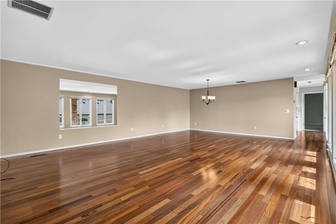 Image 3: Open concept living and dining space featuring woo