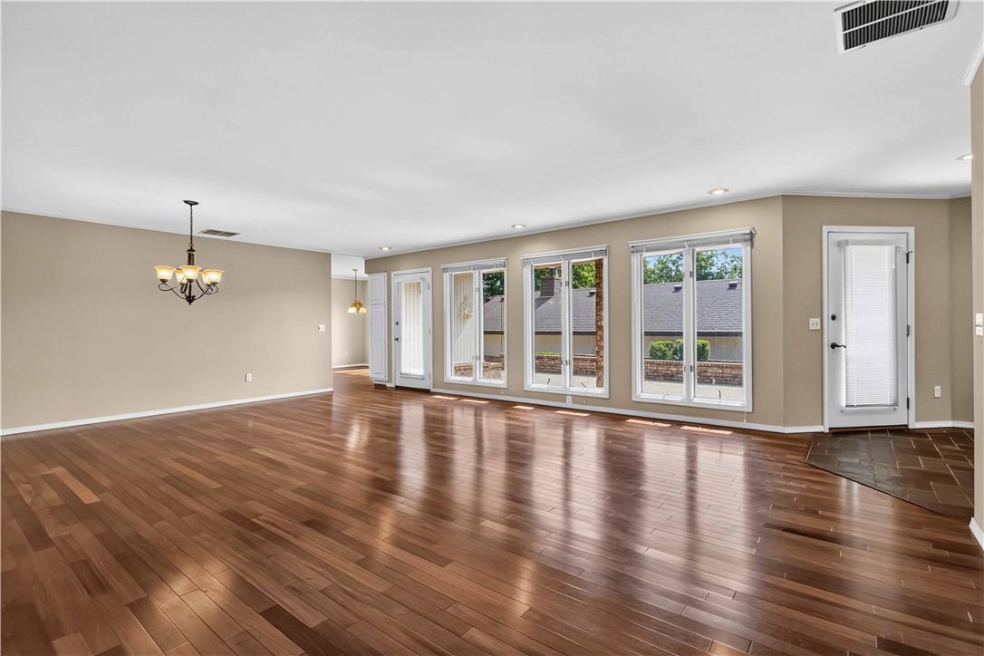 Image 4: Open concept living and dining space featuring woo
