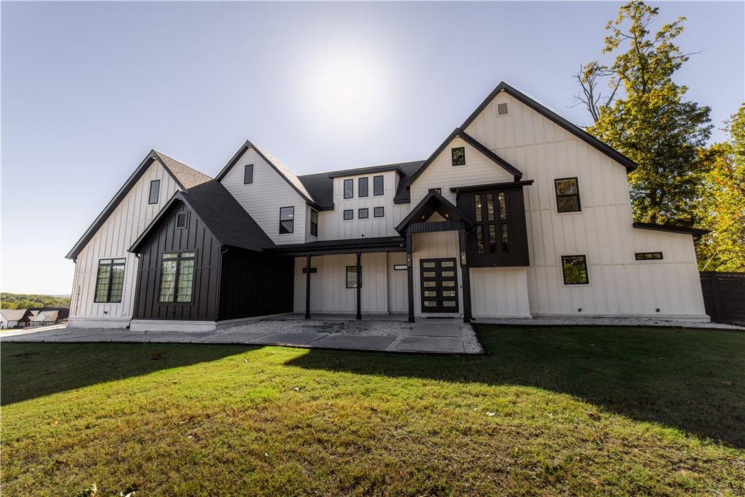 Image 2: Modern inspired farmhouse featuring a front lawn,
