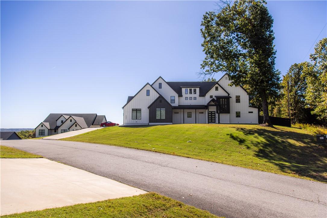 Image 3: Modern inspired farmhouse featuring a front lawn