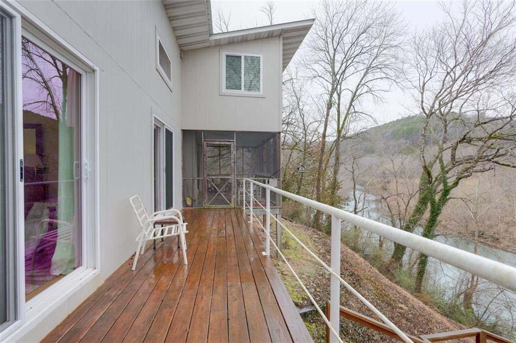 Image 2: Expansive wood deck with metal railing, offering d