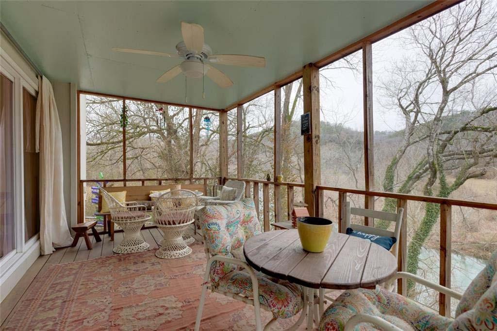 Image 3: Expansive screened porch featuring a light blue ce