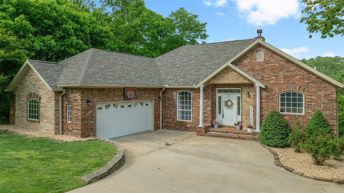 Image 2: Brick and stone-veneer exterior with an attached t