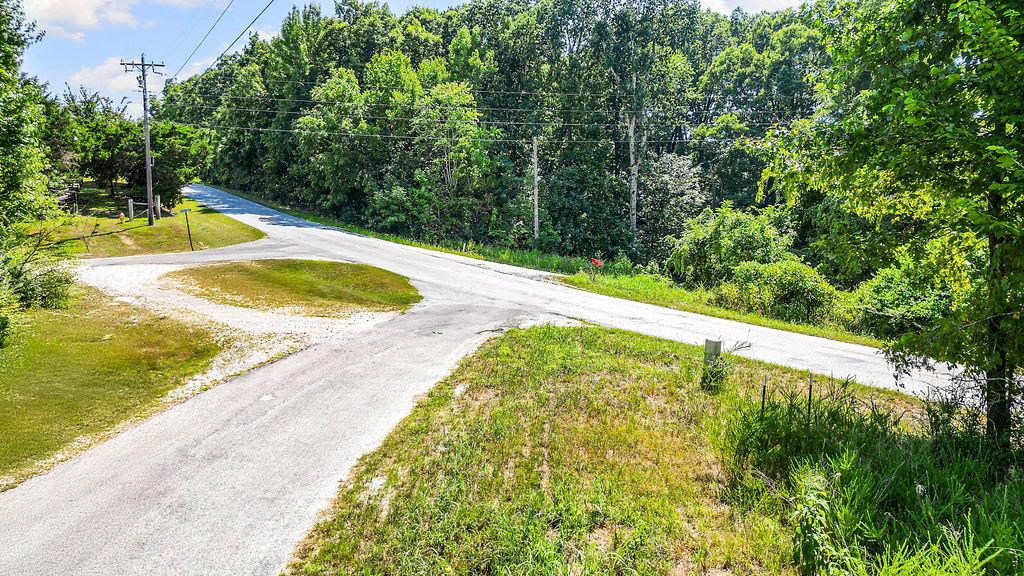 Image 3: Scenic driveway featuring a gracefully curved asph